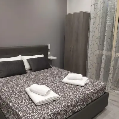 a bedroom with a bed with two pillows on it at Goccia del mare in Isola delle Femmine