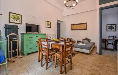 a living room with a table and chairs and a couch at Acque Di Palermo in Roccapalumba