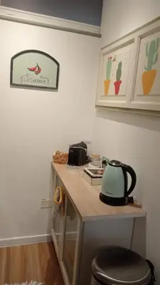 a kitchen counter with a sink and a microwave at BeeClaire Guest House in Palermo