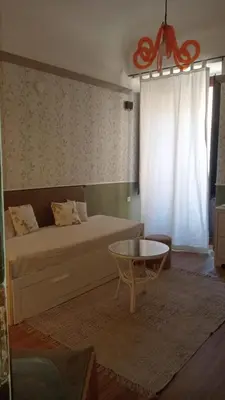 a room with a door and a table and a chair at BeeClaire Guest House in Palermo