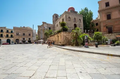 a group of people walking down a street in a city at Suite Bellini 5 Apartment in Palermo