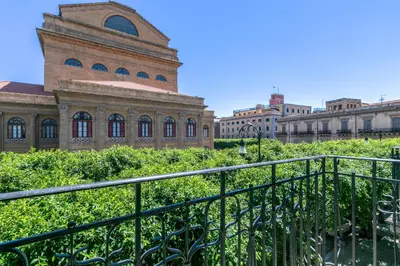 a building with a fence in front of it at GuestHost - Teatro Massimo Bright and Cozy Apartment in Palermo