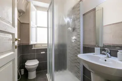 a bathroom with a sink and a toilet and a shower at GuestHost - Teatro Massimo Bright and Cozy Apartment in Palermo