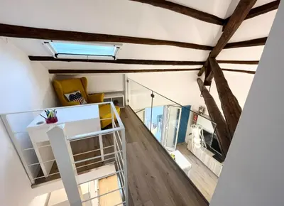 a room with wooden floors and a ceiling with beams at Casa Levante in Isola delle Femmine
