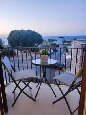 a table and chairs on a balcony with a view at Casa Levante in Isola delle Femmine