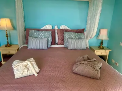 a bedroom with a bed with towels on it at Esmaraldas House of Love in Terrasini
