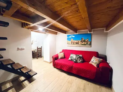 a red couch in a living room with a table at Giglio Home in Palermo