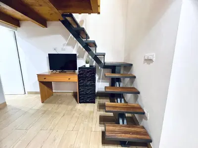 a staircase with a desk and a computer in a room at Giglio Home in Palermo
