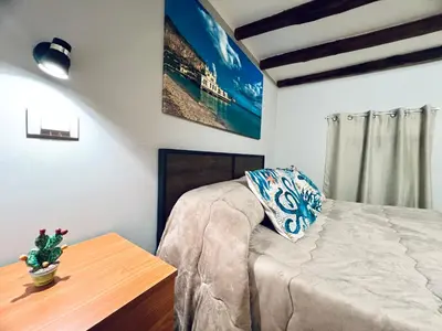 a bedroom with a bed and a table with a pillow at Giglio Home in Palermo