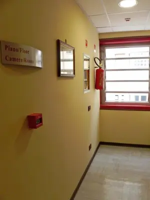 a hospital room with a window and a sign on the wall at Torreata Hotel & Residence in Palermo