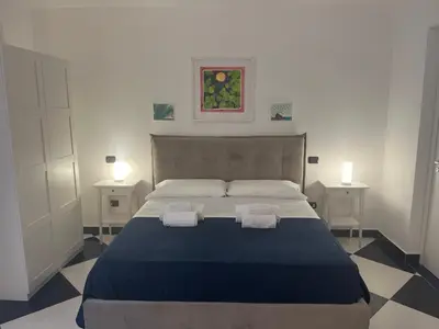 a bedroom with a large bed with two towels on it at Casa Galati in Palermo