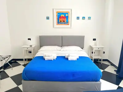 a bedroom with a blue bed with towels on it at Casa Galati in Palermo