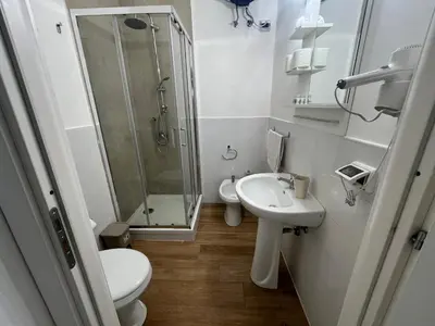 a bathroom with a toilet and a sink and a shower at Casa Galati in Palermo
