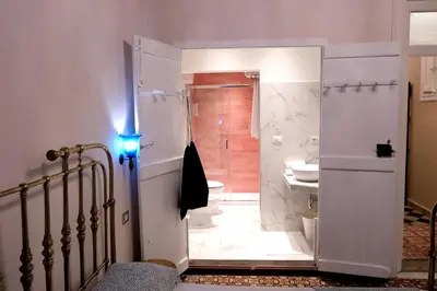a bathroom with a shower and a toilet and a sink at Belvedere Suite in Termini Imerese