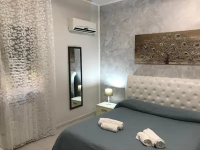 a bedroom with a bed with two towels on it at Busalacchi B&B in Mondello