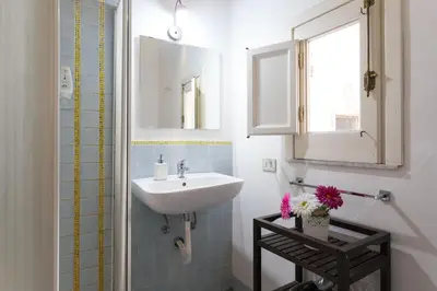 a bathroom with a sink and a mirror at Ai Tintori in Palermo
