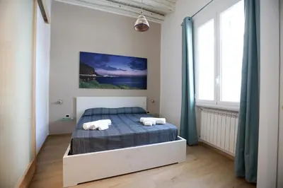 a bedroom with a bed with two towels on it at La Casetta delle Scienze Suite in Palermo