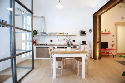 a kitchen and dining room with a table and chairs at La Casetta delle Scienze Suite in Palermo