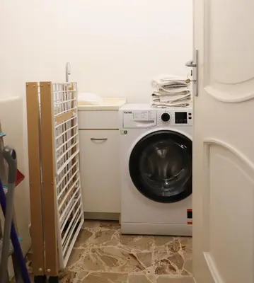 a washer and dryer in a white laundry room at Casa Costanzo in Capaci