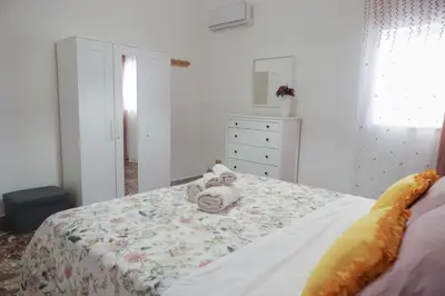 a bedroom with a bed with a stuffed animal on it at Casa Costanzo in Capaci
