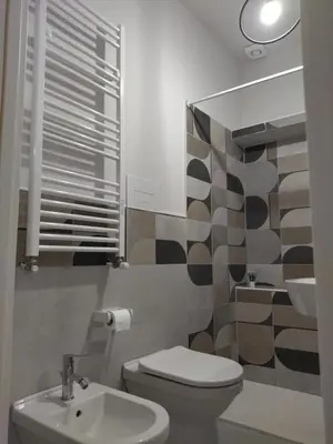 a bathroom with a toilet and a sink at Cozy apartment near Palermo Cathedral in Palermo