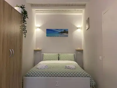 a small bedroom with a bed with two towels on it at Cozy apartment near Palermo Cathedral in Palermo