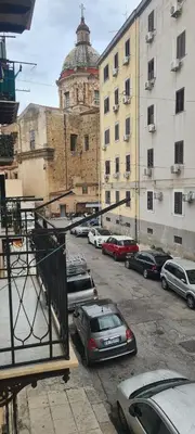 a parking lot with cars parked in front of buildings at Casa Cristy palermo in Palermo