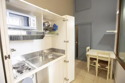 a small kitchen with a sink and a microwave at Le Plejadi in Castellammare del Golfo