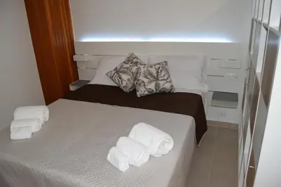 a bedroom with a bed with towels on it at Domus Ponente in Terrasini
