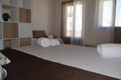 a bedroom with a large bed with towels on it at Domus Ponente in Terrasini