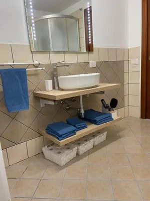 a bathroom with a sink and a mirror at FronteMare in Palermo