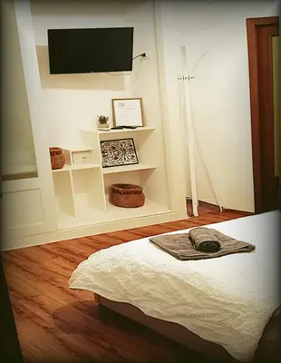a room with a bed with a tv on a wall at Casa Sedie Volanti in Palermo