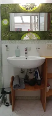 a bathroom with a sink and a mirror at Casa Sedie Volanti in Palermo
