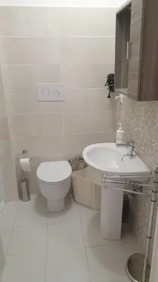 a white bathroom with a toilet and a sink at Casa Vacanze San Martino in Corleone