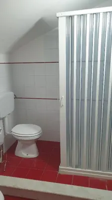 a bathroom with a toilet and a shower stall at Casa Vacanze San Martino in Corleone
