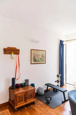 a living room with a table and a couch at Hotel La Piazzetta in Castellammare del Golfo