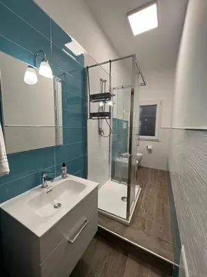 a bathroom with a sink and a glass shower at Allegracori Appartamenti in Castellammare del Golfo