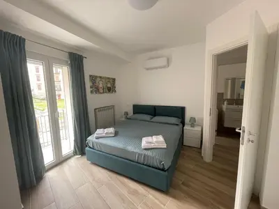 a bedroom with a bed and a large window at Casa Himera Palermo in Palermo