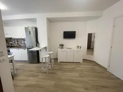 a kitchen with white cabinets and a stainless steel refrigerator at Casa Himera Palermo in Palermo
