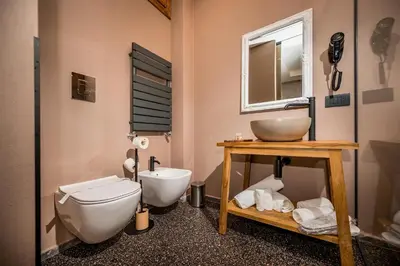 a bathroom with a toilet and a sink and a mirror at Art e Dimora - Boutique Room. in Castellammare del Golfo