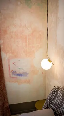 a lamp in a room with a wall at Art e Dimora - Boutique Room. in Castellammare del Golfo