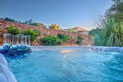 a swimming pool with glasses in the water at Villa Deluxe con Idromassaggio in Palermo