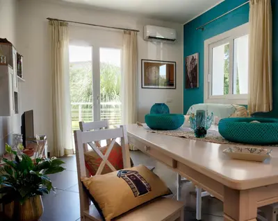 a dining room with blue walls and a table and chairs at Villa Deluxe con Idromassaggio in Palermo