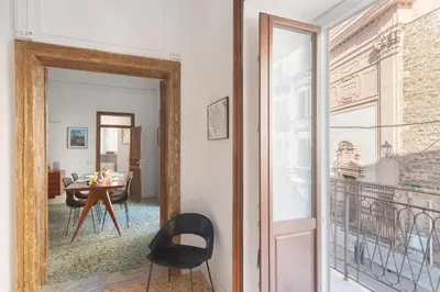 a mirror in a room with a table and a dining room at 124 Maqueda Apartments in Palermo
