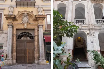 a building with a large wooden door and a building with an archway at 124 Maqueda Apartments in Palermo