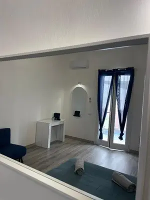 a living room with a blue couch and a window at Casa Lella Holiday Boutique in Palermo