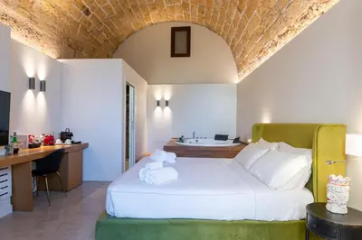 a white table topped with breakfast foods and orange juice at Bastione Spasimo Boutique Hotel in Palermo