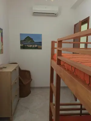 a bedroom with two bunk beds and a desk at Casa VISTA MARE in Macari
