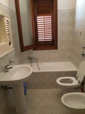 a bathroom with a sink and a toilet and a tub at Casa VISTA MARE in Macari