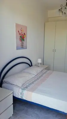 a bedroom with a bed and a dresser at Casa VISTA MARE in Macari